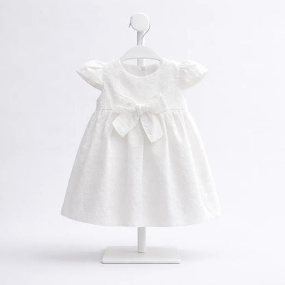 Vestido blanco para bebé niña con bordado y moño frontal