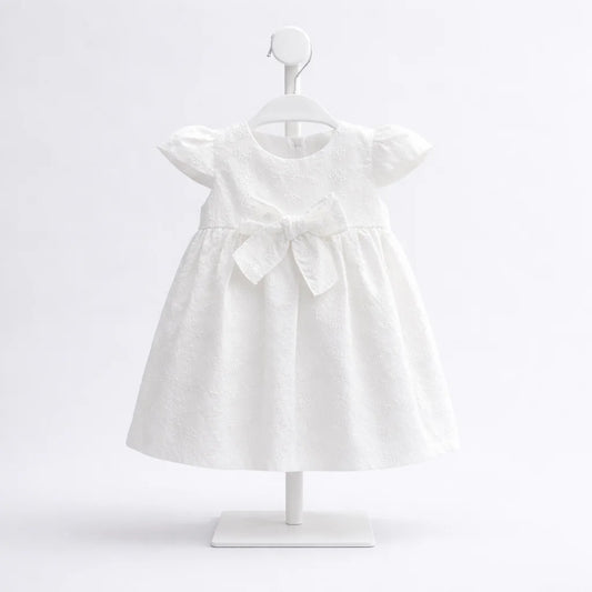 Vestido blanco para bebé niña con bordado y moño frontal